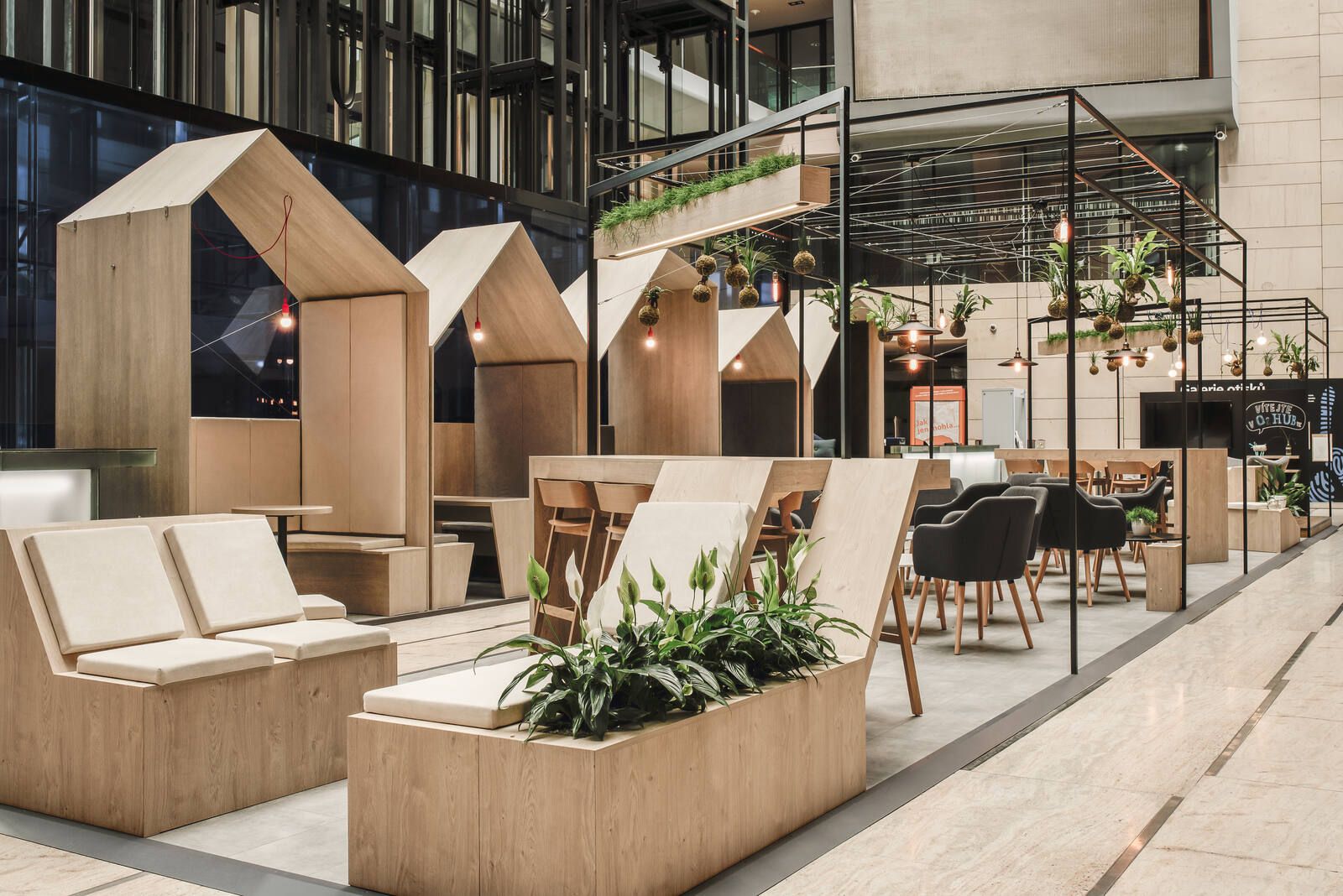 Celá zóna v atriu — meeting budky, kavárenský bar a zeleň